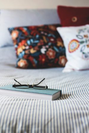 pillows and book on bed pillows and book on bed